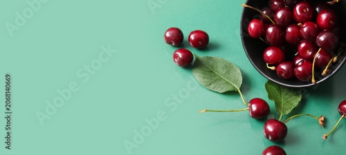Fresh red cherries in black...