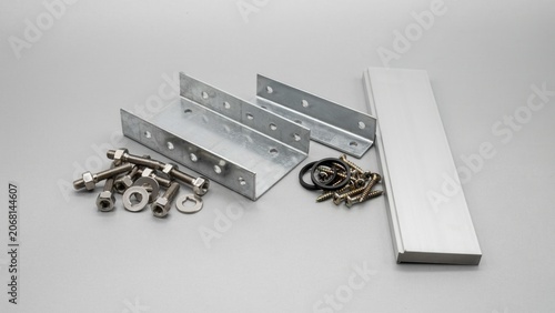 Hardware components consist of galvanized metal brackets and assorted nuts and bolts for construction assembly projects.