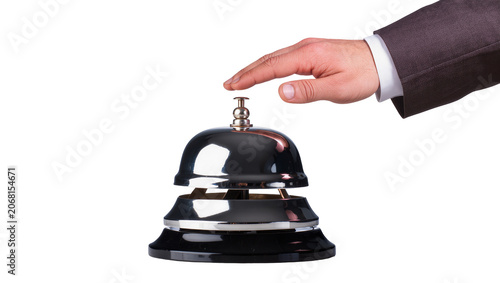 Canvas Print Isolated hand pressing a shiny metal service bell, symbolizing customer assistan