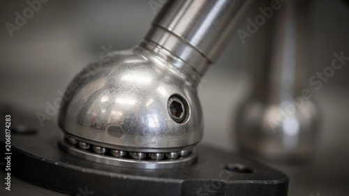Ball joint mechanism rotates on a heavy black base to allow for precise movement in high quality industrial equipment.