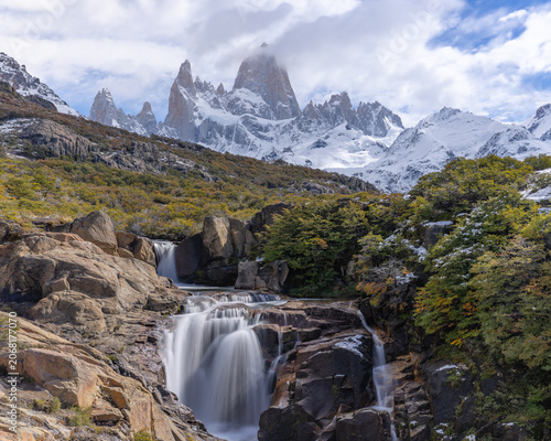 a long exposure shot of secret waterfall and monte fitz roy on an autumn afternoon in los glaciares national park of patagonian argentina