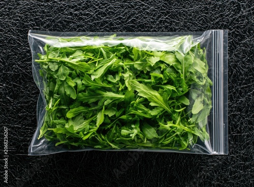 Fresh green leafy vegetable sealed in a clear plastic bag