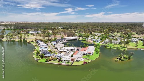 Waterfront houses and apartments occupy a curved lakeside peninsula