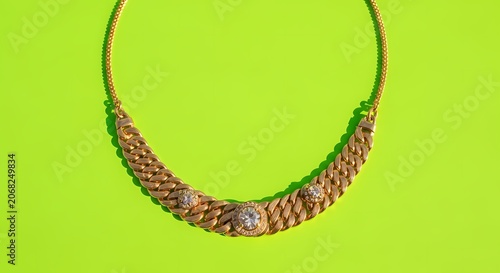 Elegant Gold Chain Necklace with Diamonds on Bright Green Background