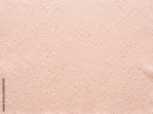 Soft pink paper with subtle fiber texture background.