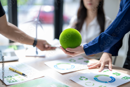 Business people discussing esg sustainability with green orb