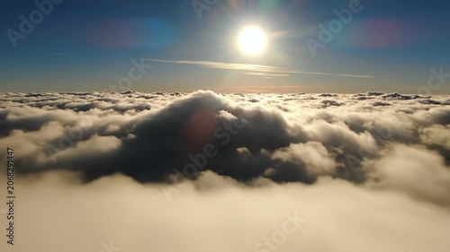 Bright sun shining over a vast sea of white fluffy clouds