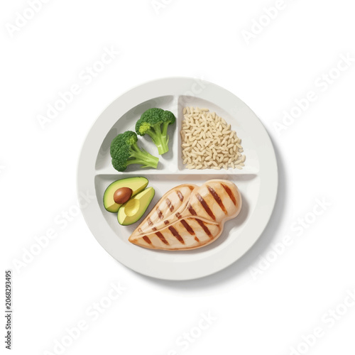 Balanced meal with chicken broccoli rice and avocado on divided plate for healthy diet and fitness
