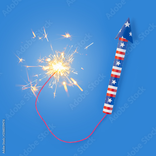 Fourth of July rocket firework with long braided fuse and burning sparks. Lit firework in USA colors of red, white, and blue for patriotic US American 4th of July or America's Independence day.