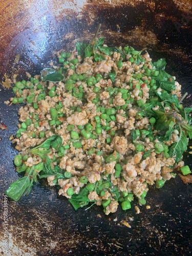 The picture shows Thai food: Stir-fried long beans with minced pork, basil, and kaffir lime leaves.