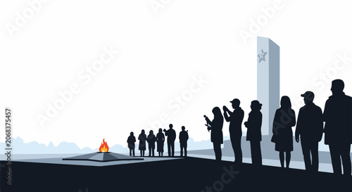 A group of people standing near a monument and a fire pit
