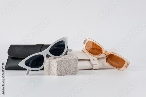 Sunglasses, fashion eyewear, and a glasses case against a white background.