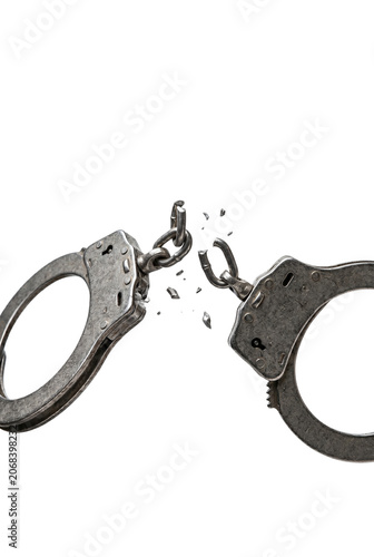 фотографія Broken metal handcuffs snapping in half