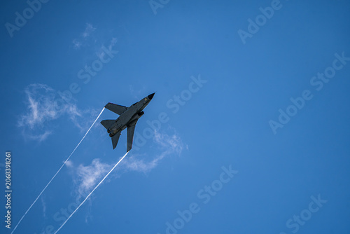 Berlin, Berlin, Germany - 14 June 2026: View of a Panavia Tornado jet performing an aerial display with contrails against a clear blue sky at the ILA Berlin Air Show.