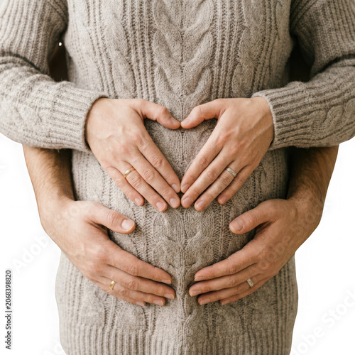 Couples Hands Forming Heart Shape on Pregnant Belly.