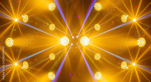 Vibrant golden lights shining brightly in a mesmerizing pattern of rays and beams creating a dynamic visual effect with warm hues and radiant glow.