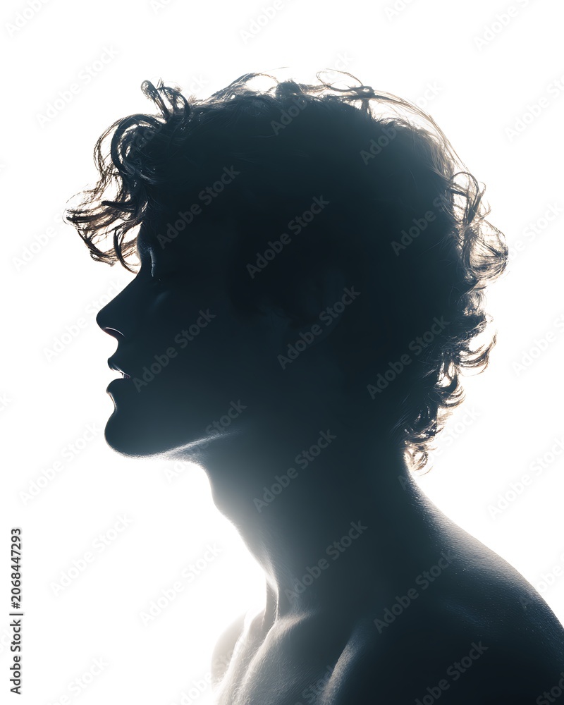 Fototapeta premium Silhouette of a young man with curly hair in profile against a bright white background.