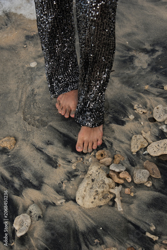 Barefoot Woman Walking on Black Sand Beach and Rocks