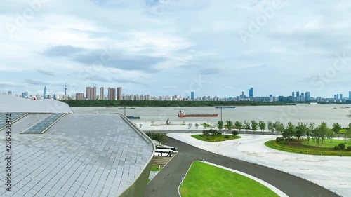 Modern Riverside Architecture and City Skyline Under Cloudy Sky