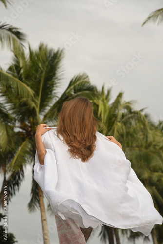 Back View of Woman with Long Hair in White Dress Outdoors