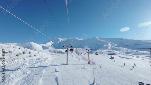Chairlift Over Snowy Mountain Ski Resort on Sunny Winter Day