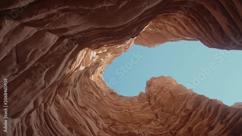 Sandstone Cave Opening to Blue Sky in Desert Rock Formation