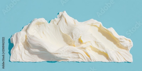 White cosmetic cream smear swirled on blue background for skin care advertising, minimalist beauty product texture for moisturizing brand aesthetic with copy space