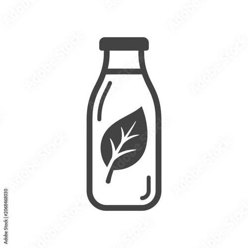 Glass bottle with green leaf.