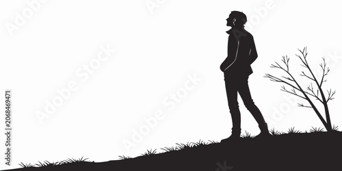 Obraz na płótnie Silhouette of a contemplative man standing on a slope in nature looking towards