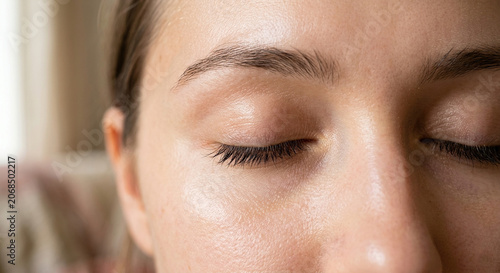 Close-up of a woman with closed eyes and smooth skin