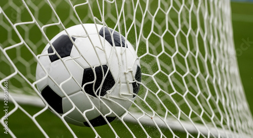 Bilde på lerret High-speed shot of a soccer ball impacting the goal net during a scoring moment