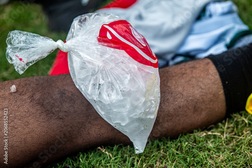 Partial view of an ice bag on a man's knee