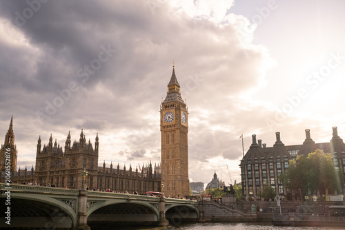 Big Ben and the House of Commons glowing in warm golden hour lig