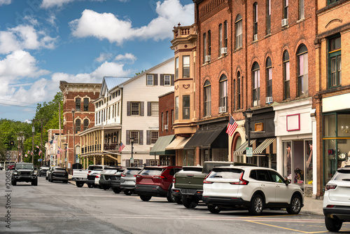Quadro su tela Historic brick storefronts and parked cars along Front Street in the