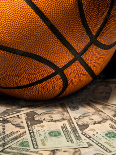 Basketball gambling concept on a pile of US dollar bills