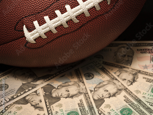 Football gambling concept on a pile of US dollar bills