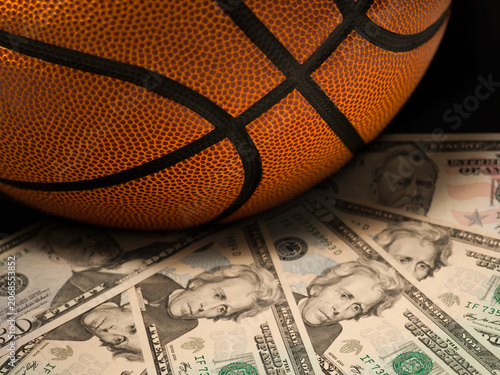 Basketball gambling concept on a pile of US dollar bills