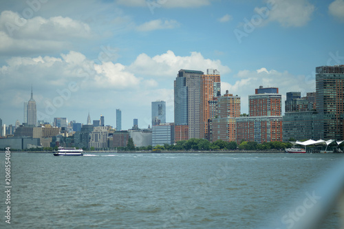 Riverfront skyline with boat and city buildings