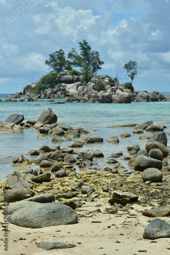 Rocky shoreline with clear turquoise water and sky