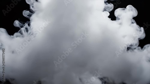 A striking image showcases ethereal white smoke gently rising against a stark black background, creating a dramatic and mysterious visual effect.