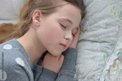 Sweet little girl sleeping in a bed