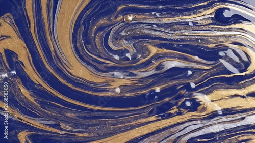 A mesmerizing abstract artwork showcases swirling patterns of deep blue, shimmering gold, and elegant silver, creating a dynamic and luxurious visual experience.
