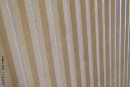 Fotografie Closeup corrugated metal surface texture with vertical lines, ideal for industrial and architectural backgrounds