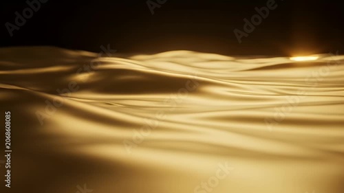 A shimmering, abstract golden surface undulates against a dark background, creating a luxurious and fluid visual effect.