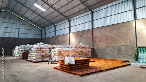 Obraz na plátne a warehouse for storing agricultural commodities, such as stacks of rice sacks o