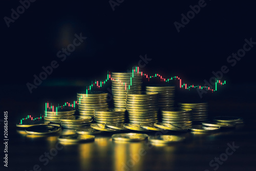 Coin stacks and candlestick chart on dark background representing stock market trading, investment strategy, wealth accumulation, financial growth, economic trends, and profitable opportunities.