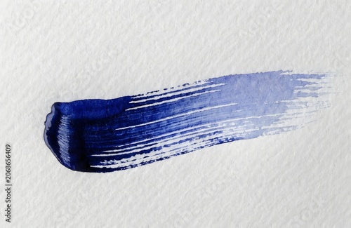 Blue paint brush stroke on white textured background with gradient effect