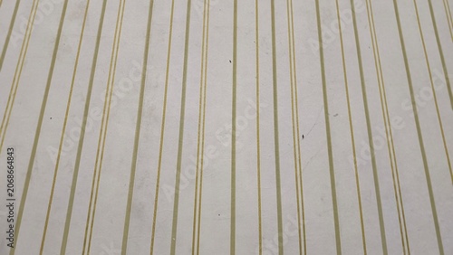 Obraz na płótnie Close-up texture of cream vintage wallpaper with vertical golden stripes pattern