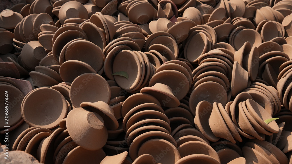 Fototapeta premium Stacked Handmade Clay Bowls Creating Pottery Texture Background