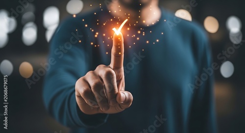 Man's finger touching glowing spark with bokeh lights background, pointing